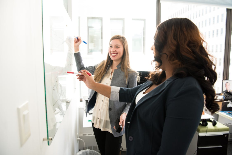 People writing on a board