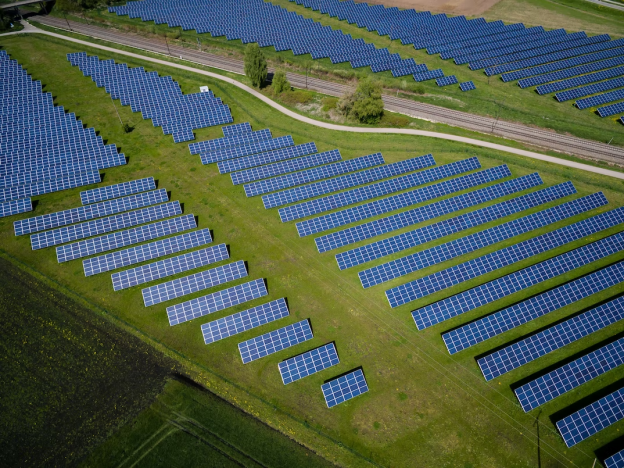 A grid of photovoltaic panels on a field