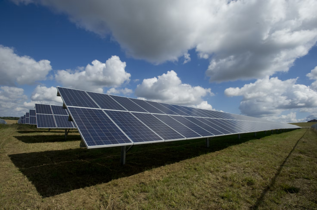 An image of a solar panel field under the bright sky