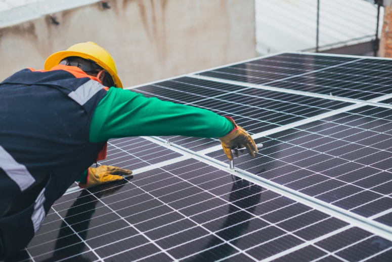 An image of a worker installing a solar panel