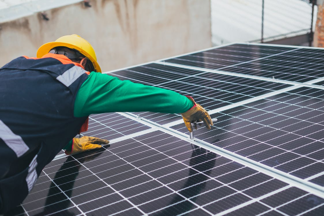 An image of a worker installing a solar panel